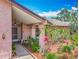 Charming covered front entrance features lush landscaping and inviting curb appeal at 3932 Watson Dr, New Port Richey, FL 34655