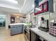 Updated kitchen with modern appliances, including a red microwave, and ample counter space with a view to outdoors at 3932 Watson Dr, New Port Richey, FL 34655