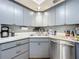Corner kitchen with stainless steel appliances, modern cabinets, and a stainless steel sink at 3932 Watson Dr, New Port Richey, FL 34655