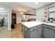 Open-concept kitchen island with seating that flows into the living room at 3932 Watson Dr, New Port Richey, FL 34655