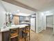 Open-concept kitchen with seating at the island flows to the rest of the house at 3932 Watson Dr, New Port Richey, FL 34655