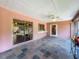Enclosed patio with tile floors, ceiling fan and sliding doors at 3932 Watson Dr, New Port Richey, FL 34655