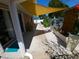 Backyard patio featuring a shade covering, landscaping, and lush vegetation at 404 Oakmount Rd, Clearwater, FL 33765