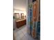 Bathroom with tile flooring, dual sinks, and a shower with patterned curtain at 404 Oakmount Rd, Clearwater, FL 33765