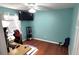 Well-lit room featuring hardwood floors, a ceiling fan, and a TV at 404 Oakmount Rd, Clearwater, FL 33765