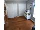 Bedroom with hardwood flooring, multiple closets, and unique wallpaper accents at 404 Oakmount Rd, Clearwater, FL 33765