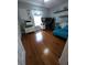 Functional bedroom designed as an office with hardwood flooring, and a comfortable blue daybed at 404 Oakmount Rd, Clearwater, FL 33765