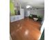 Spacious living room featuring hardwood floors, a ceiling fan, and a comfortable leather couch at 404 Oakmount Rd, Clearwater, FL 33765
