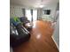 Well-lit living room featuring hardwood floors, modern TV, and an open layout ideal for entertaining guests at 404 Oakmount Rd, Clearwater, FL 33765