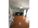 Cozy living room with hardwood floors, a ceiling fan, and sliding glass doors for natural light at 404 Oakmount Rd, Clearwater, FL 33765