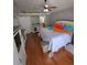 Spacious main bedroom with wood floors, stylish decor, and ample natural light at 404 Oakmount Rd, Clearwater, FL 33765