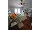 Bright main bedroom featuring wood floors, a ceiling fan, and a decorative accent wall at 404 Oakmount Rd, Clearwater, FL 33765