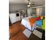 Charming main bedroom featuring wood floors, ceiling fan, and stylish furniture and decor at 404 Oakmount Rd, Clearwater, FL 33765