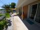 Back patio with a sail shade cover, concrete pavers, and mature landscaping at 404 Oakmount Rd, Clearwater, FL 33765