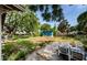 A spacious backyard with lush greenery and a charming blue shed, perfect for relaxation and outdoor activities at 41 W Boyer St, Tarpon Springs, FL 34689