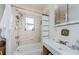 Tiled bathroom featuring a shower-tub, sink with counter, and mirrored medicine cabinet at 41 W Boyer St, Tarpon Springs, FL 34689