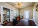 Bedroom featuring hardwood floors, ceiling fan, doorway to bathroom, and door to backyard at 41 W Boyer St, Tarpon Springs, FL 34689