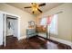 Bedroom featuring hardwood floors, ceiling fan, and door to closet with natural light from window at 41 W Boyer St, Tarpon Springs, FL 34689