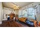 Cozy bedroom with wood floors and a large window, featuring a ceiling fan and decorative touches at 41 W Boyer St, Tarpon Springs, FL 34689