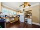 An open kitchen featuring wood floors, light cabinets, a ceiling fan, and large windows that provide natural light at 41 W Boyer St, Tarpon Springs, FL 34689
