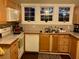 Bright kitchen with wood cabinets, modern appliances and three windows at 41 W Boyer St, Tarpon Springs, FL 34689