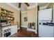 Vintage kitchen with an older washer, dryer, storage, and dark hardwood floors at 41 W Boyer St, Tarpon Springs, FL 34689