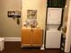 Well-lit laundry area with a stackable washer and dryer unit and storage cabinet at 41 W Boyer St, Tarpon Springs, FL 34689