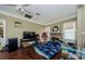 Spacious living area featuring a fireplace, TV, and hardwood floors at 41 W Boyer St, Tarpon Springs, FL 34689