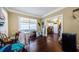 Bright living area featuring a view to the kitchen, a table, and hardwood floors at 41 W Boyer St, Tarpon Springs, FL 34689