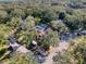 Overhead shot showcases a backyard oasis with a screened pool, complemented by verdant landscaping at 44 Pinewood Cir, Safety Harbor, FL 34695