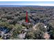 High-angle view of a residential area with tree-lined streets and houses, offering a sense of community and nature at 44 Pinewood Cir, Safety Harbor, FL 34695