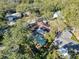 Aerial perspective highlighting a home's screened-in pool area and the surrounding lush, green backyard at 44 Pinewood Cir, Safety Harbor, FL 34695