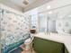 This spacious bathroom includes nautical-themed shower curtain and vanity at 44 Pinewood Cir, Safety Harbor, FL 34695