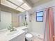 Bathroom with shower, white tile, and bright window at 44 Pinewood Cir, Safety Harbor, FL 34695