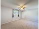 Bedroom features plush carpet, ceiling fan, and window with curtains at 44 Pinewood Cir, Safety Harbor, FL 34695