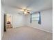 Comfortable bedroom with neutral carpet, ceiling fan and window with blue curtains at 44 Pinewood Cir, Safety Harbor, FL 34695