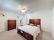 Spacious bedroom with plush carpet, ceiling fan, and wooden dresser at 44 Pinewood Cir, Safety Harbor, FL 34695