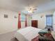 Bedroom features a ceiling fan, plush carpet, and window with curtains at 44 Pinewood Cir, Safety Harbor, FL 34695