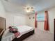 Bedroom features a ceiling fan, plush carpet, and window with curtains at 44 Pinewood Cir, Safety Harbor, FL 34695