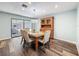 Cozy dining area with wood-look flooring, a classic hutch, and sliding glass doors to the pool at 44 Pinewood Cir, Safety Harbor, FL 34695