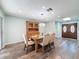 Charming dining room featuring wood floors, an elegant chandelier, and a classic hutch at 44 Pinewood Cir, Safety Harbor, FL 34695