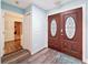 Welcoming foyer featuring wood-look flooring and a stylish double-door entrance and closet at 44 Pinewood Cir, Safety Harbor, FL 34695