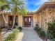 Inviting front entrance with stone accents, lush landscaping, and a vibrant double-door entryway at 44 Pinewood Cir, Safety Harbor, FL 34695
