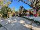 A home's exterior featuring a sign and tropical landscaping at 44 Pinewood Cir, Safety Harbor, FL 34695