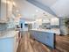 Bright kitchen with stainless steel appliances, stylish backsplash, and gray kitchen island at 44 Pinewood Cir, Safety Harbor, FL 34695