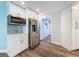 Updated kitchen with white cabinets, stainless appliances, and access to other areas of the home at 44 Pinewood Cir, Safety Harbor, FL 34695