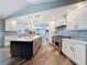 Beautiful kitchen featuring a large island, stainless appliances, white cabinets, and stylish tile backsplash at 44 Pinewood Cir, Safety Harbor, FL 34695