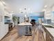 Bright, open kitchen featuring a large island with wine cooler, stainless steel appliances, and tile backsplash at 44 Pinewood Cir, Safety Harbor, FL 34695