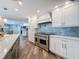 Spacious kitchen with modern appliances, island, custom cabinets, and stylish backsplash at 44 Pinewood Cir, Safety Harbor, FL 34695