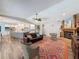 Living room view towards the kitchen, with a stone fireplace and cozy seating area at 44 Pinewood Cir, Safety Harbor, FL 34695